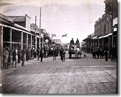 Grass Valley in the 1860s, after reconstruction following the fire of 1855.  Note the wooden planks as roadbed.  Source:  California State Library.